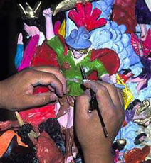 Artist painting a ceramic figure