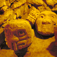 Stone heads with animal and human attributes