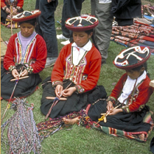 Young girls spinning yarn