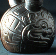 Chavín blackware stirrup vessel depicting a crocodilian head