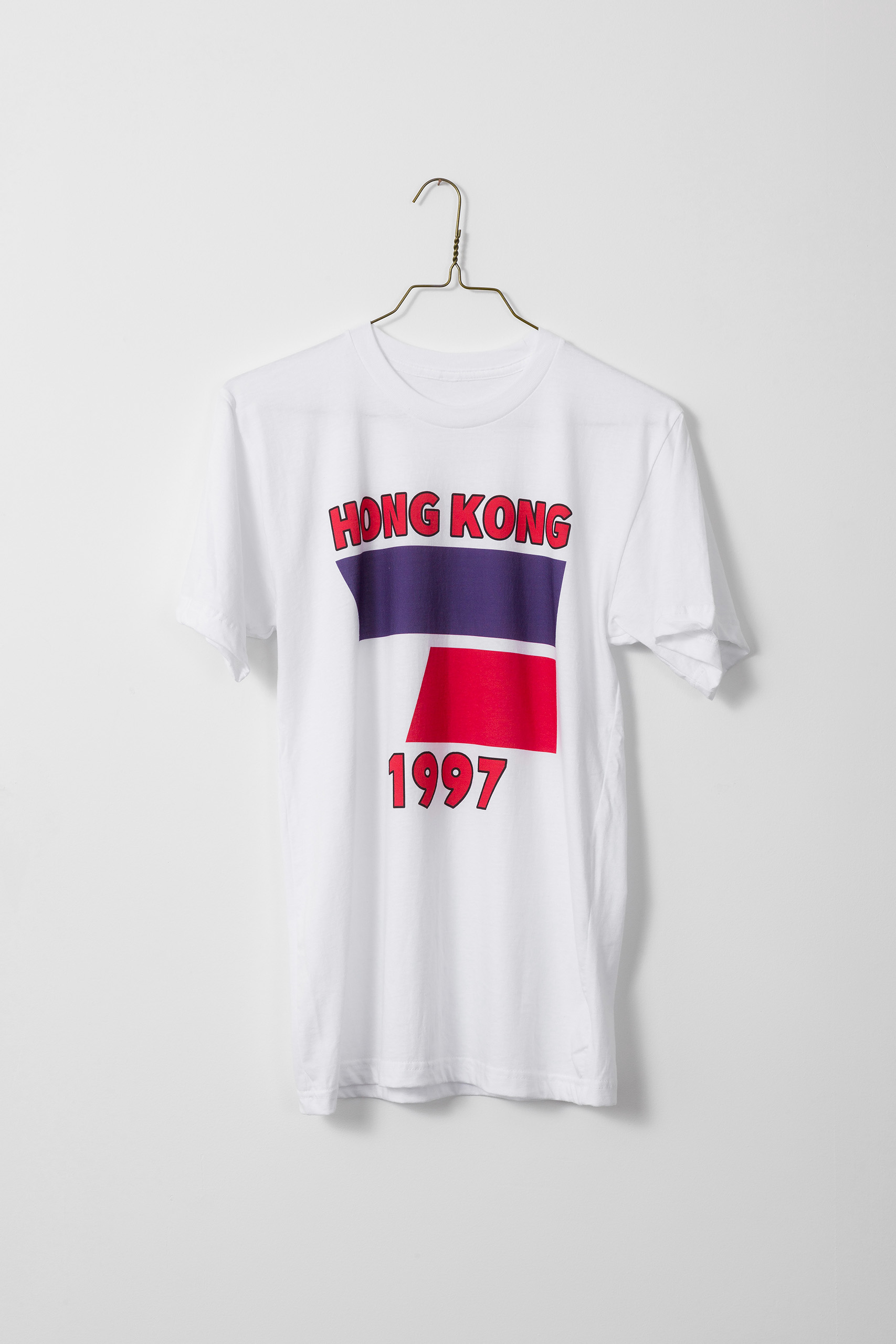 White t-shirt with blue and red flag and the words "HONG KONG" above and "1997" below