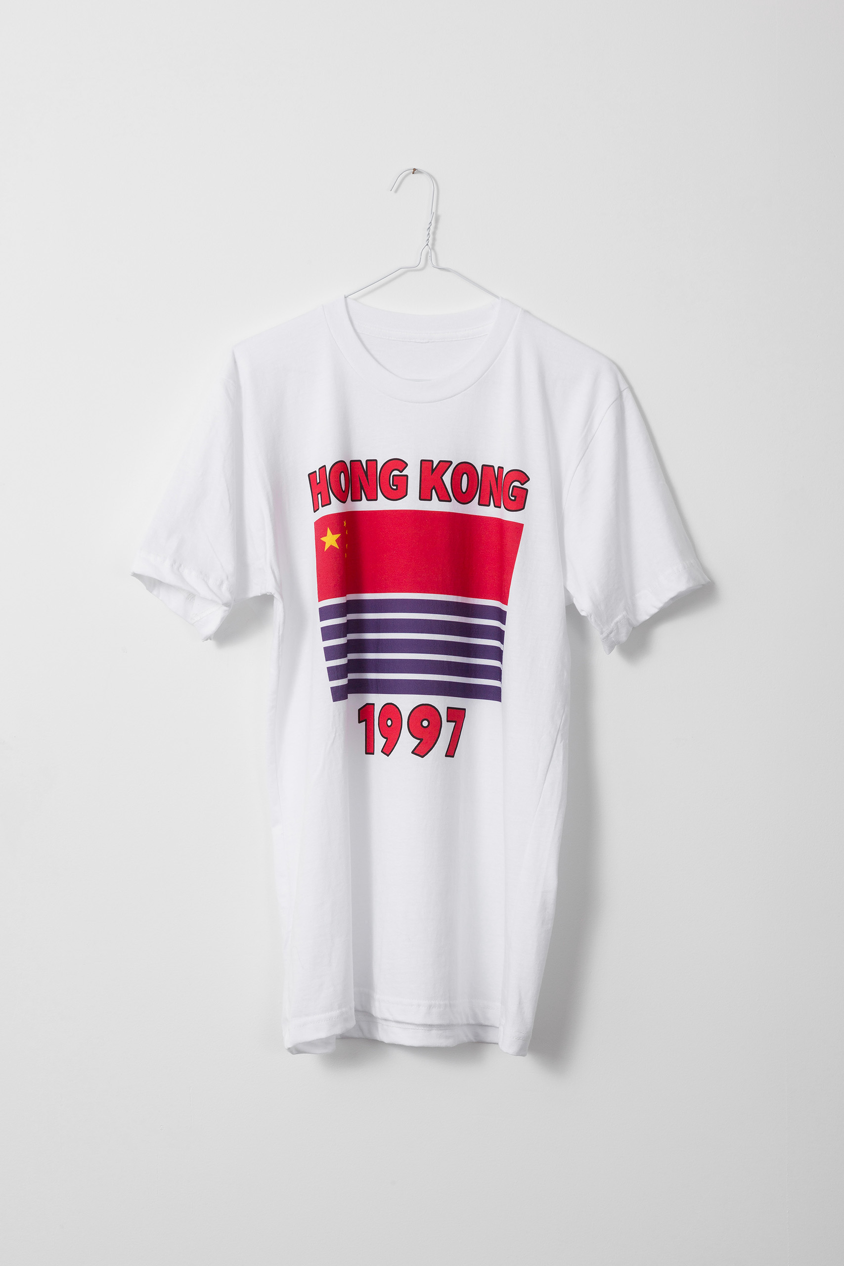 White t-shirt with a half red, half blue and white striped flag and the words "HONG KONG" above and "1997" below