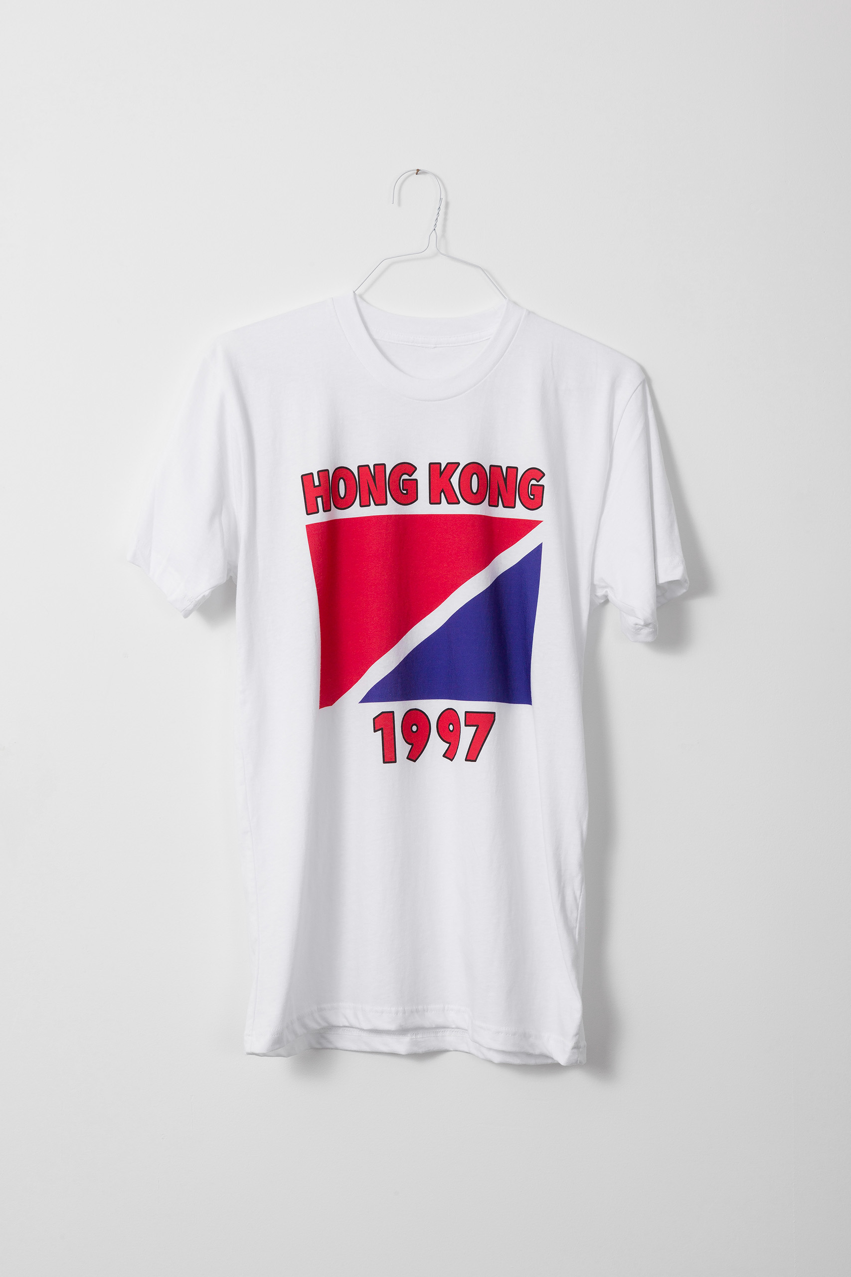 White t-shirt with a flag diagonally split between red and blue, with "HONG KONG" above and "1997" below