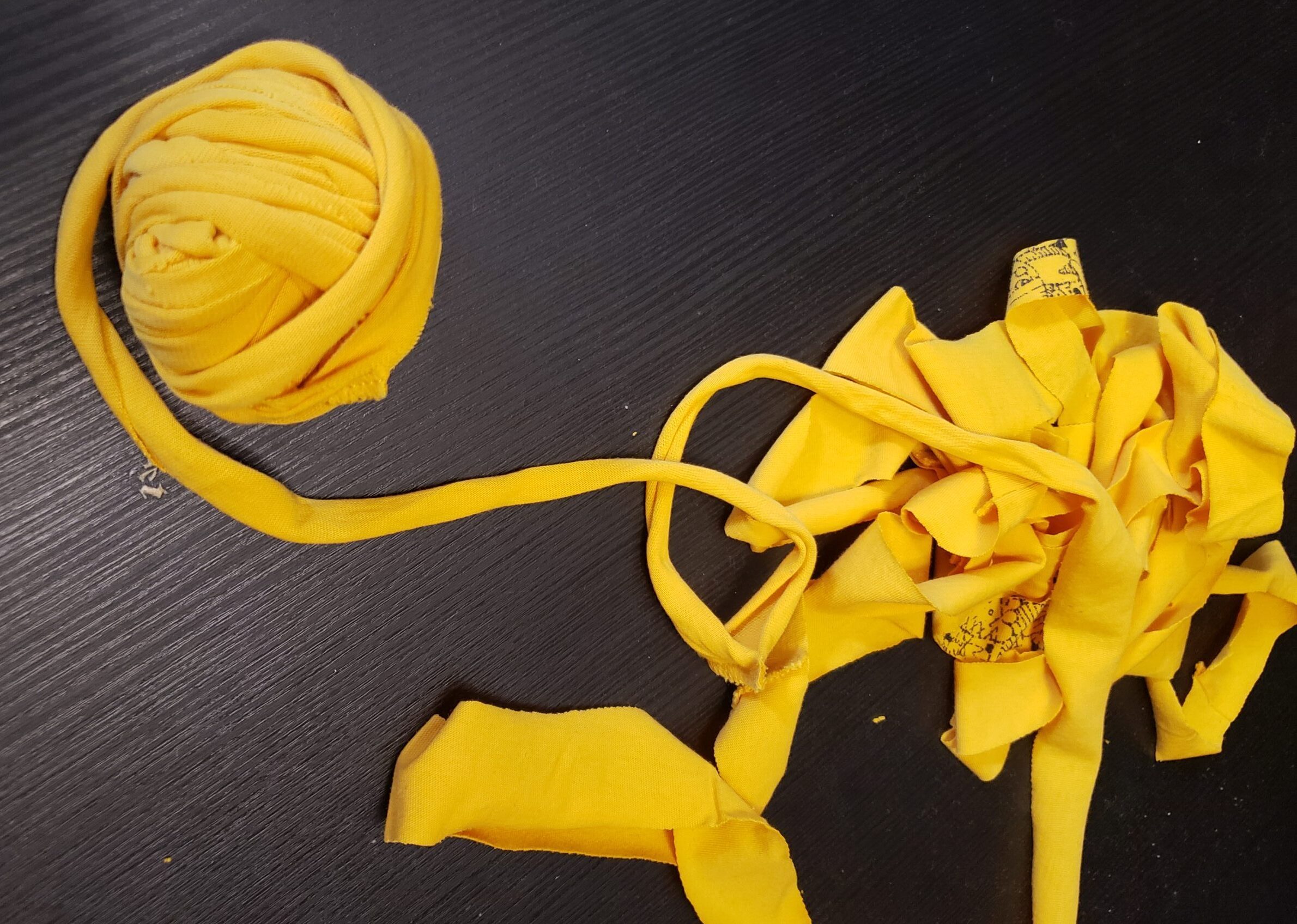 a yellow ball of yarn made from a yellow t-shirt