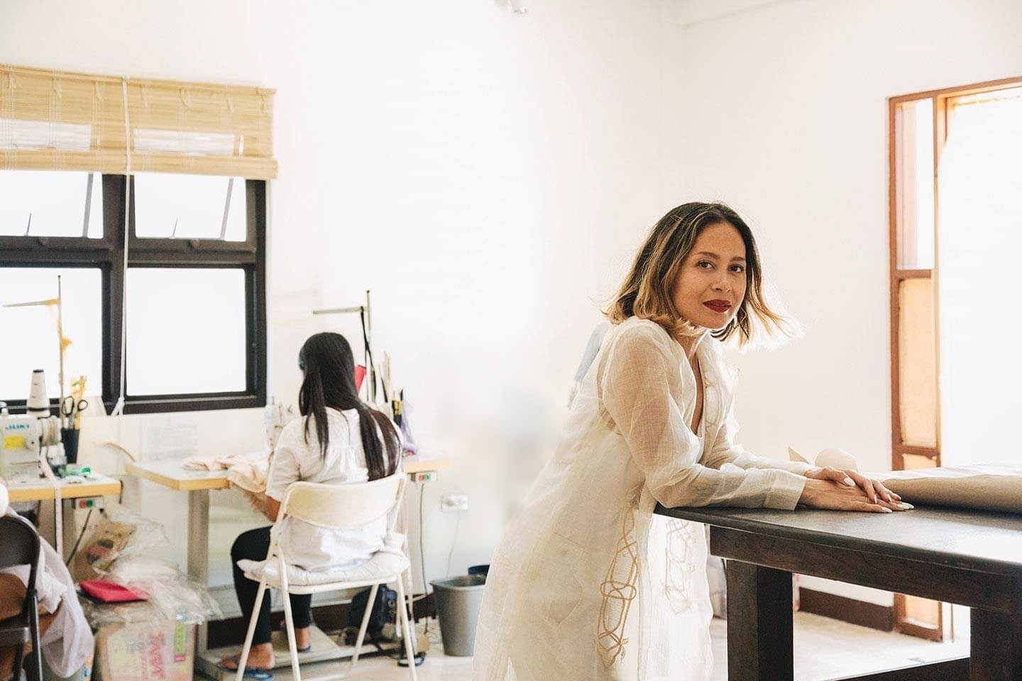 This image shows the fashion designer in her studio