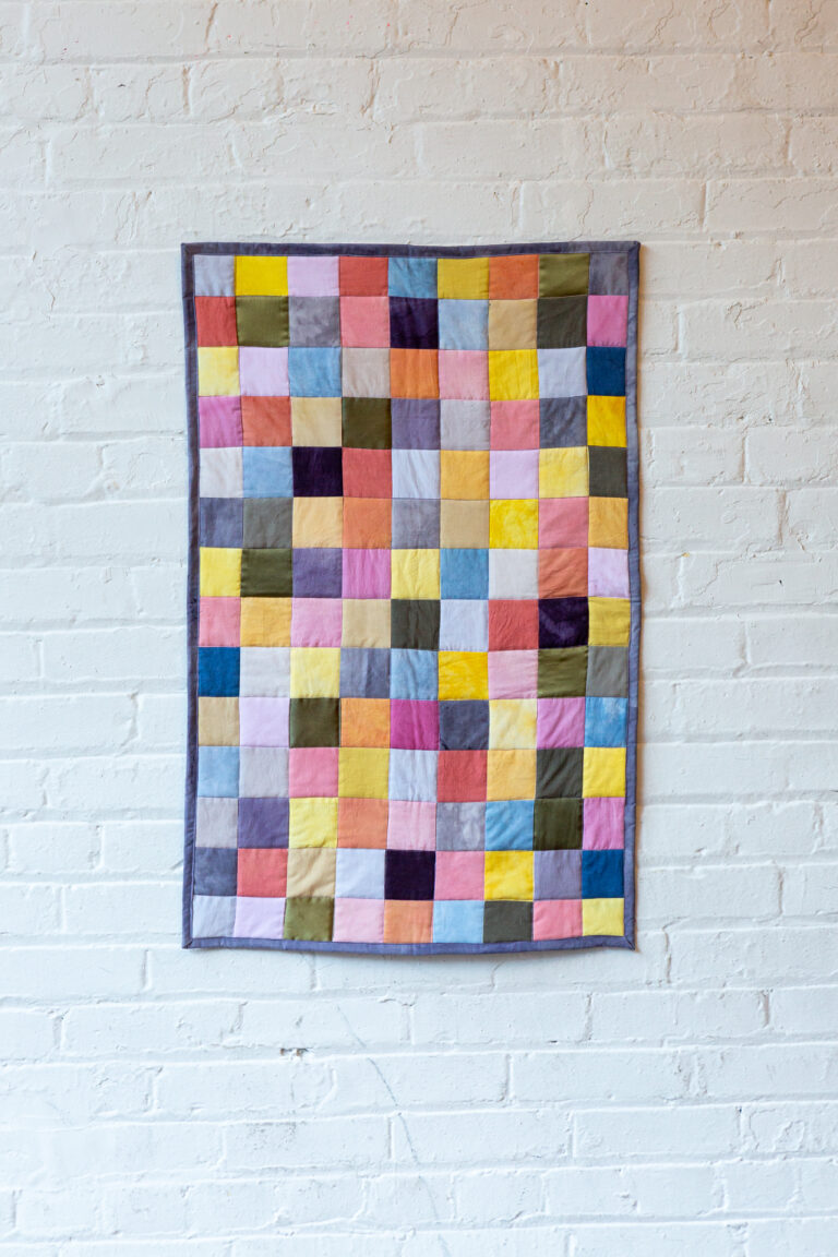 This image shows a textile quilt by artist Holly Chang